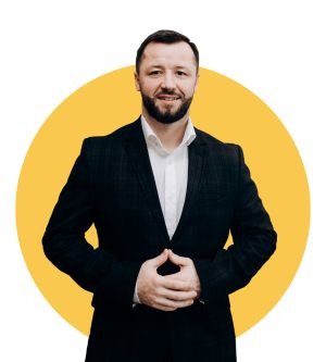 Myron Korostil in a dark jacket and white shirt